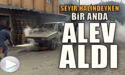 SEYİR HALİNDEYKEN ALEV ALAN OTOMOBİLE İLK MÜDAHALEYİ ÇEVREDEKİ ESNAF YAPTI