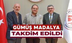 BŞEÜ'YE GÜMÜŞ MADALYA VE MADALYA BERATI TAKDİMİ