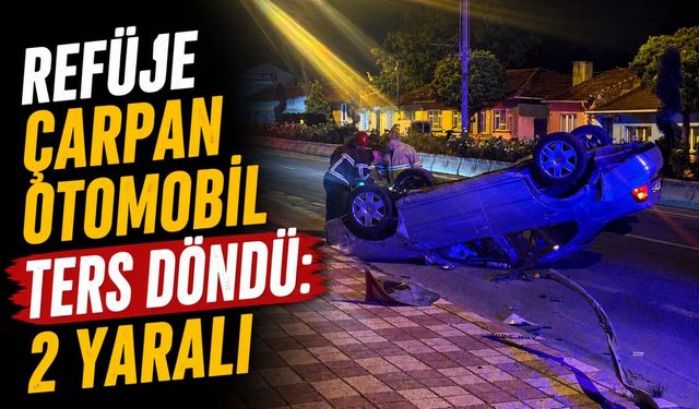 REFÜJE ÇARPAN OTOMOBİL TERS DÖNDÜ: 2 YARALI