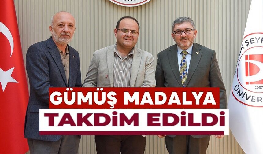 BŞEÜ'YE GÜMÜŞ MADALYA VE MADALYA BERATI TAKDİMİ